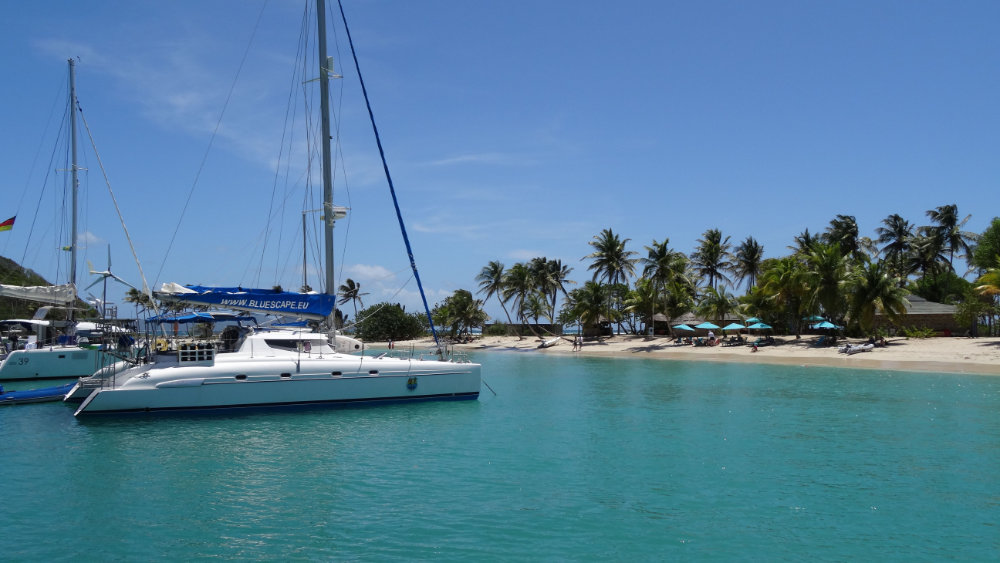 Swedish archipelago with numerous small islands, sailing yacht, sunset golden light, aerial view